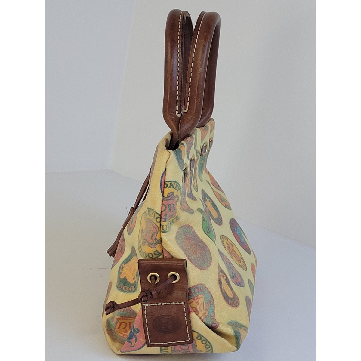 Vintage Y2K Dooney & Bourke Medallion Coated Canvas Tassel Tote/Satchel