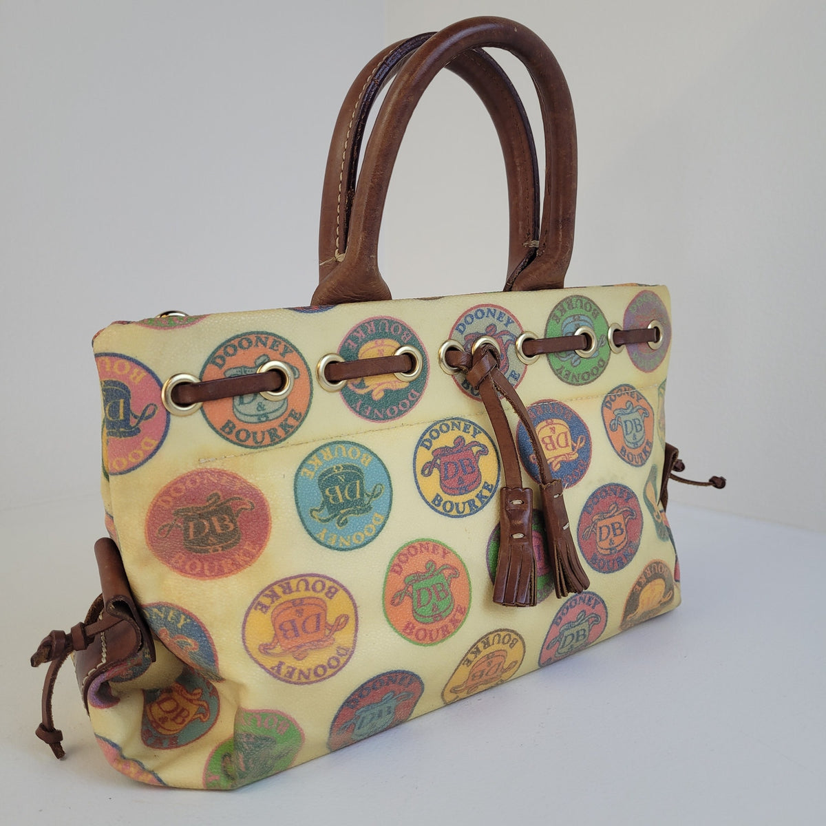 Vintage Y2K Dooney & Bourke Medallion Coated Canvas Tassel Tote/Satchel